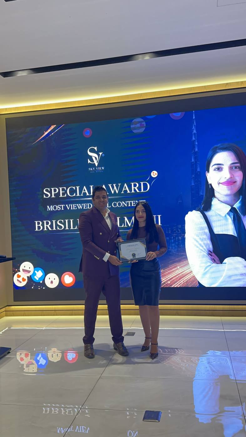 Brisi receiving the Most Viewed Content award at Sky View Real Estate